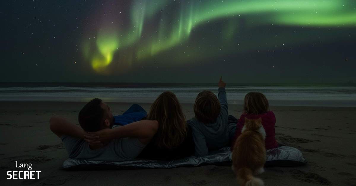 Семья наблюдает танцующее северное сияние над Атлантическим океаном на уединенном пляже острова Skye